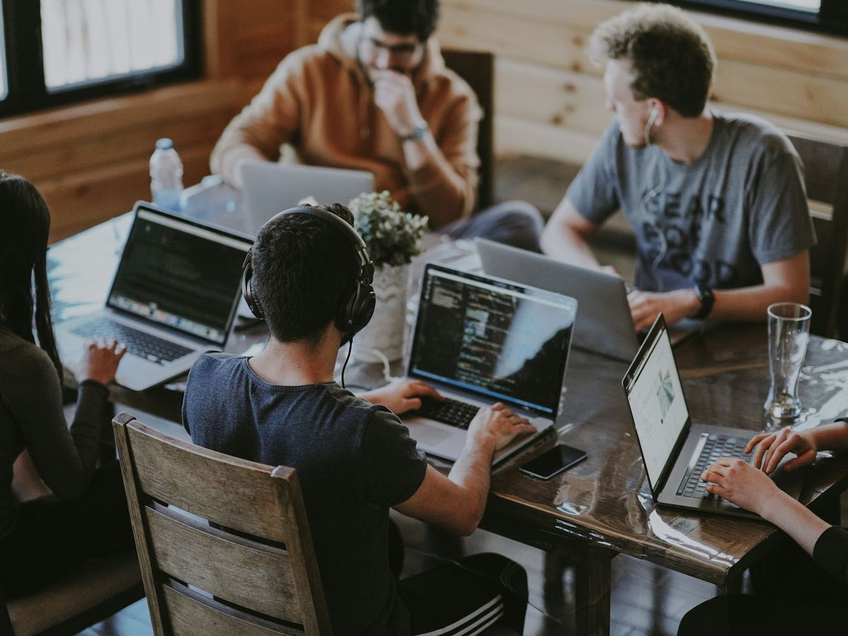 A group of students working together on laptops