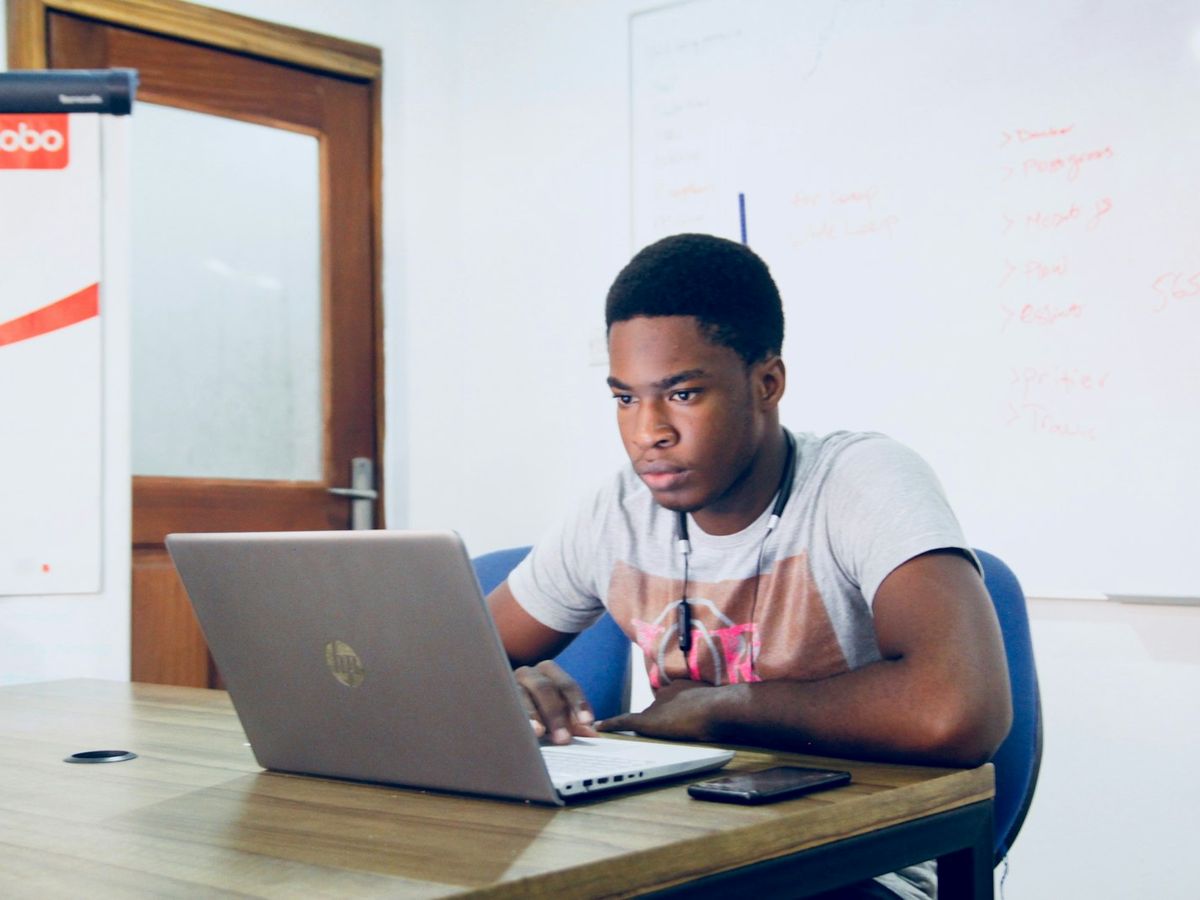 A student working through practice questions on a laptop